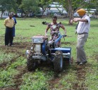 Project team demonstrating a two-wheeled tractor at the project launch. Photo: CIMMYT