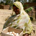 Woman showing eggs collected from village chickens - Tanzania Photo credit M Wood, AIFSRC