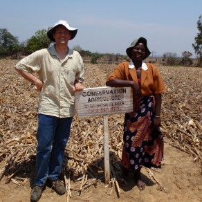People standing next to a sign identifying a farm practising conservation agriculture, Malawi. (Photo: M Gyles ACIAR)