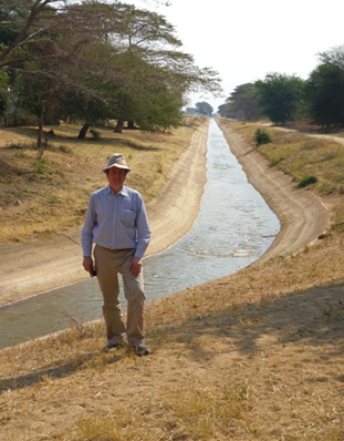 Project leader Jamie Pittock standing next to the Madibira Irrigation Scheme. Credit P. Ramshaw, ANU 