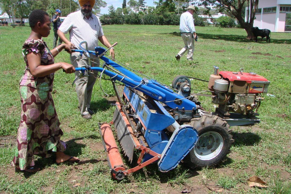 A female farmer using two-wheel tractor fitted with a Chinese-designed conservation agriculture planter. Photo credit CIMMYT