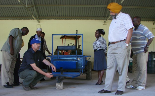 Project team members examining small scale tractor at the project launch in March 2013. Photo credit: CIMMYT
