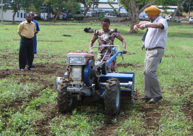Project team demonstrating a two-wheeled tractor at the project launch. Photo: CIMMYT